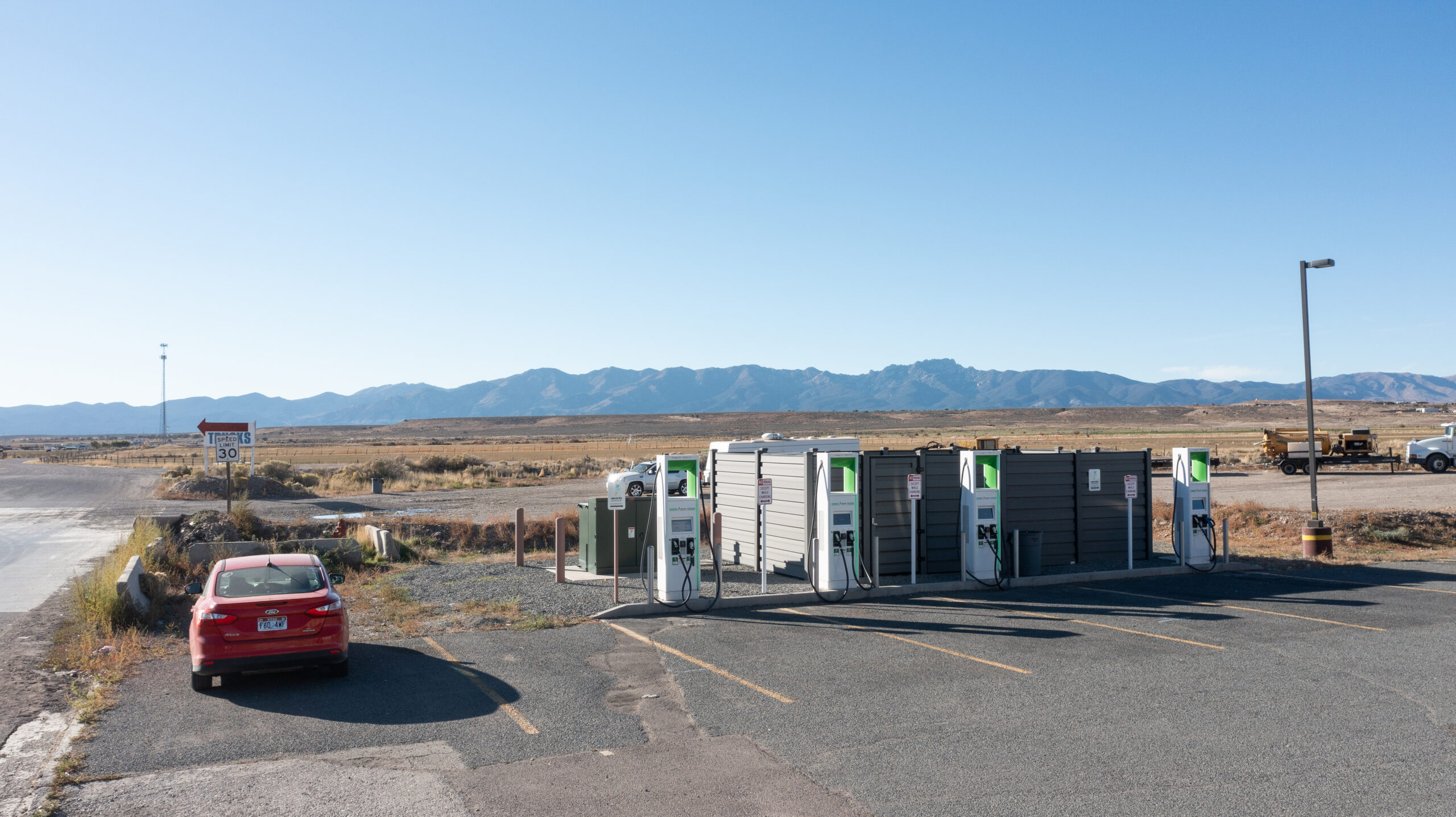 EV charging station overlooking a mountain valley landscape