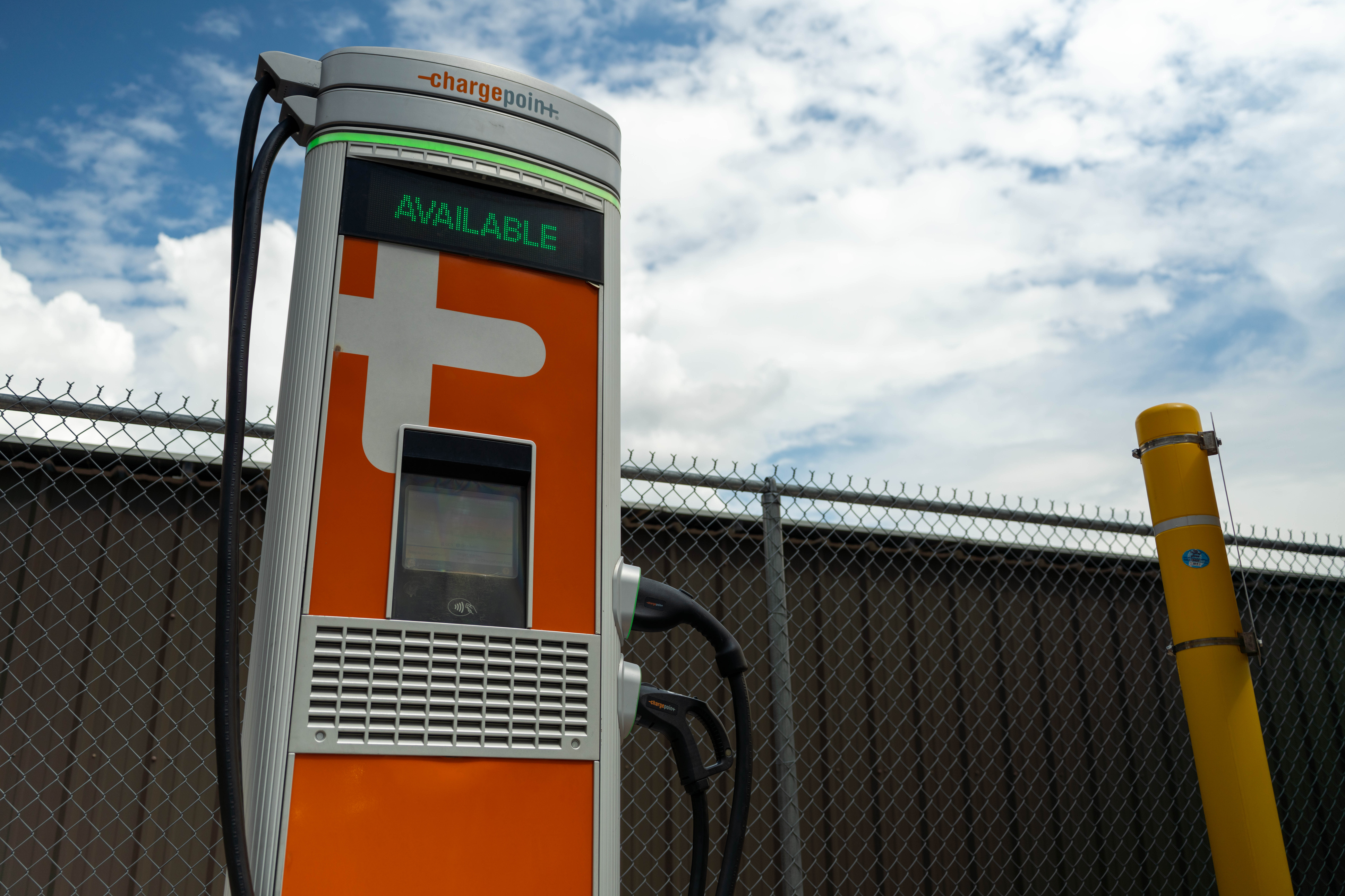 An orange electric vehicle charging station