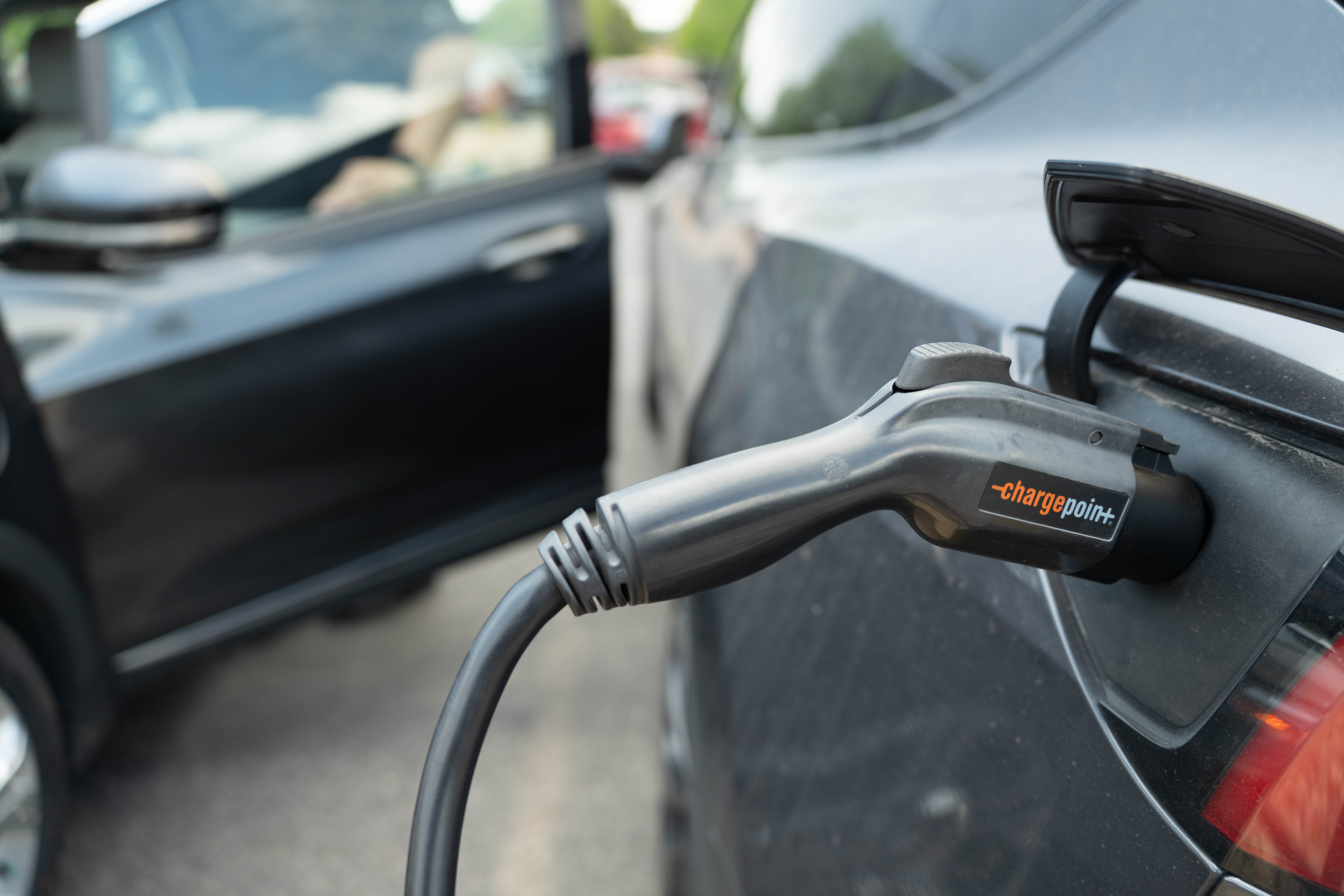 A close-up of an electric vehicle using a charger