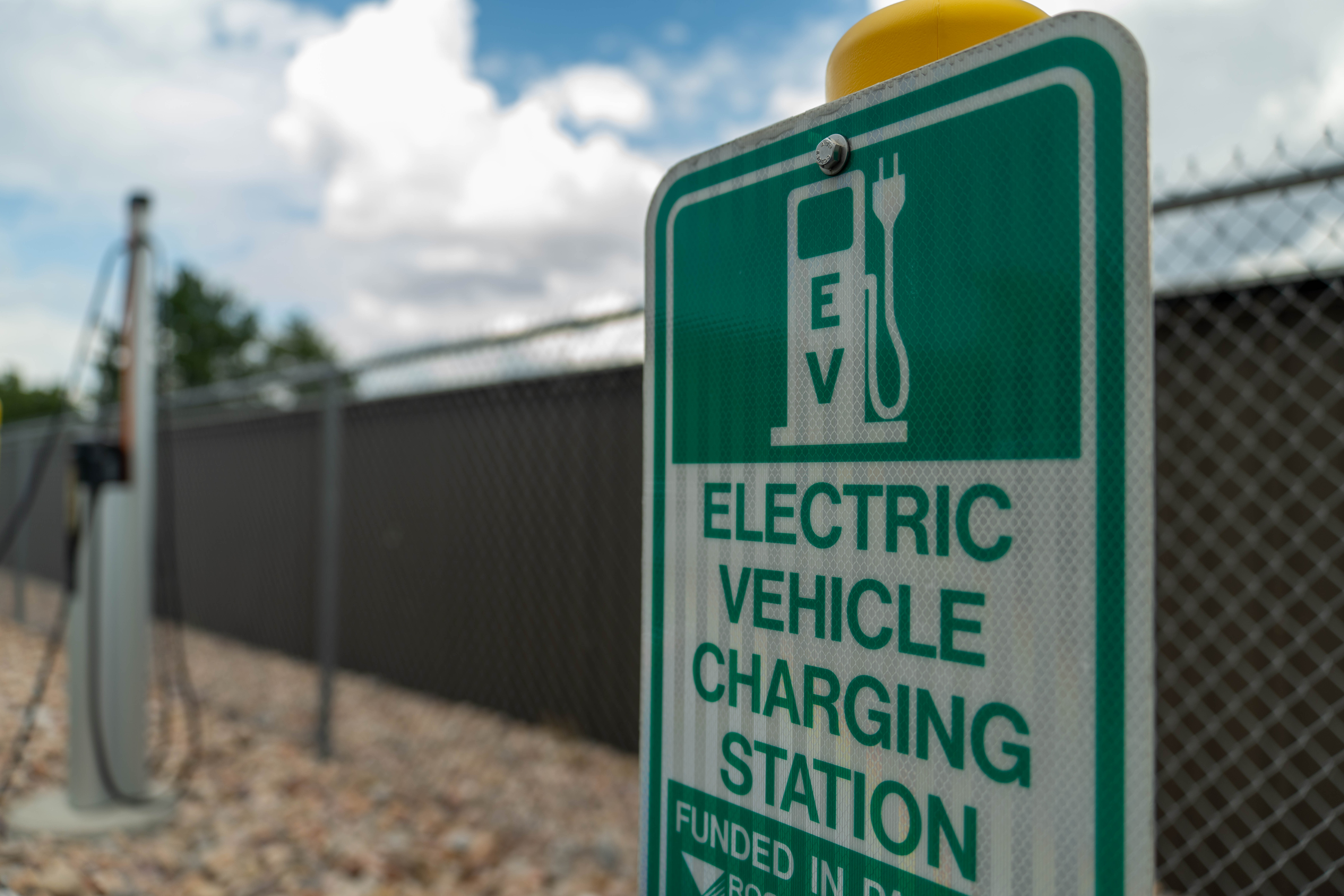 A sign reads "Electric Vehicle Charging Station"